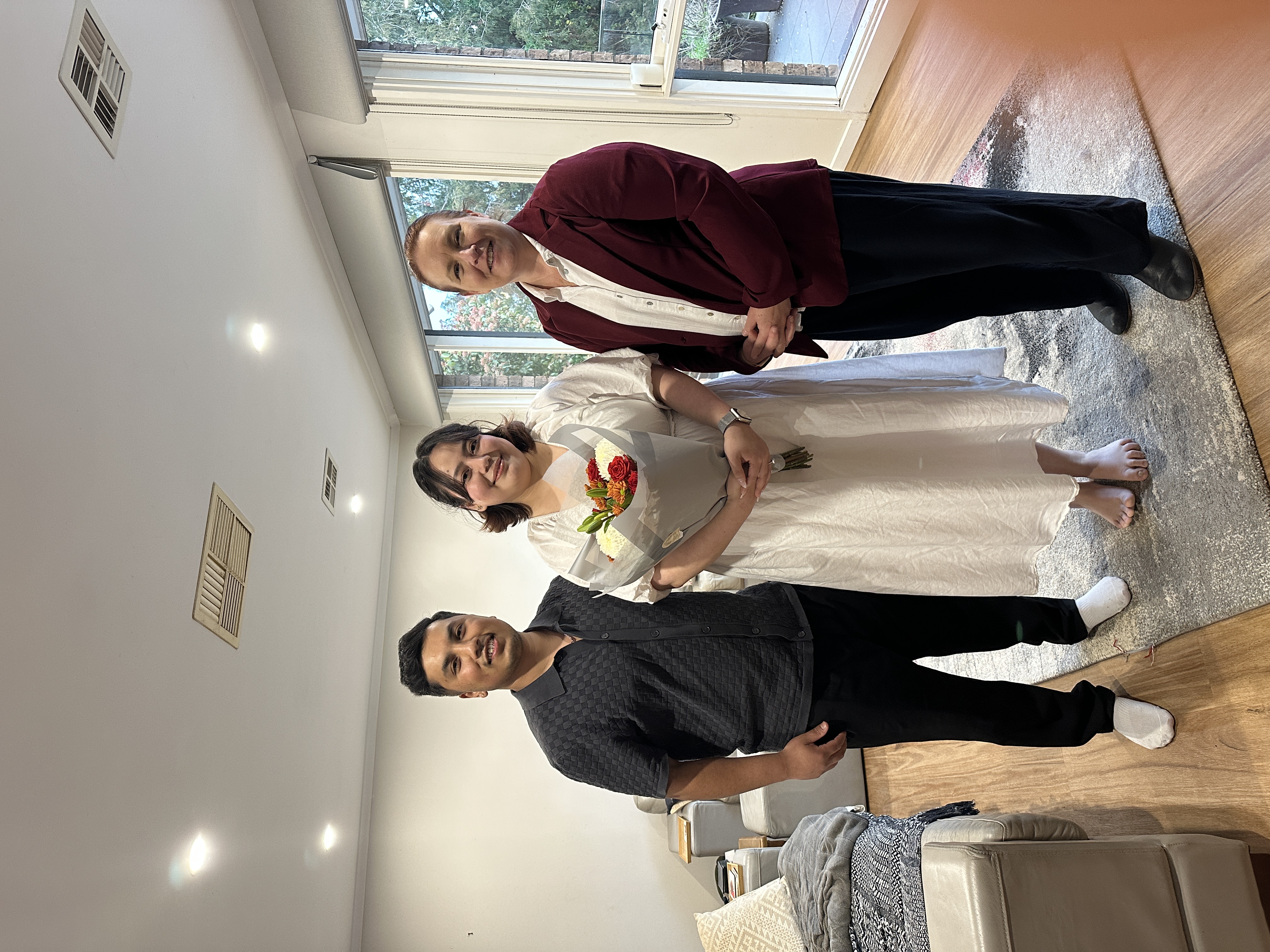 Allison Barker with a couple after a relaxed home wedding ceremony