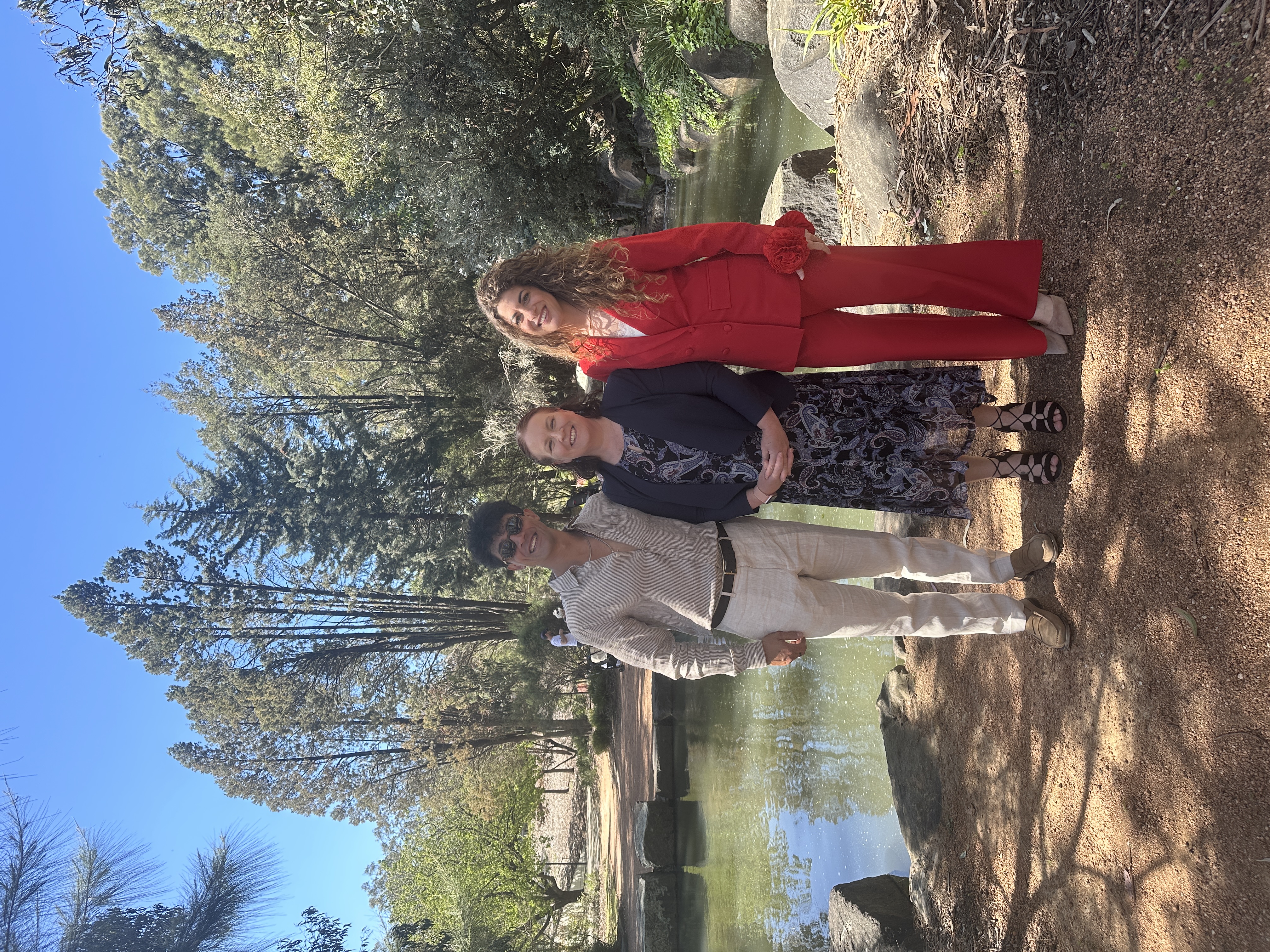 Allison Barker with a couple beside a pond in a Canberra park